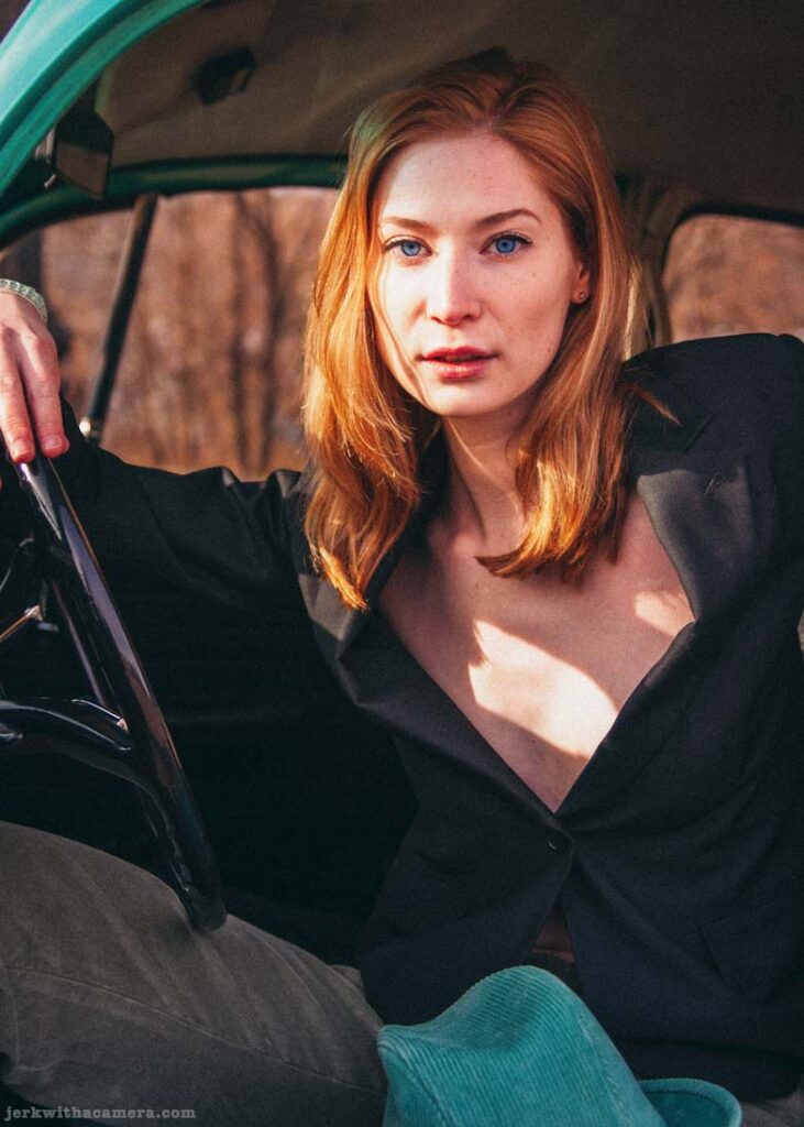 Twilla Coates sitting inside a Volkswagen Beetle looking toward the camera