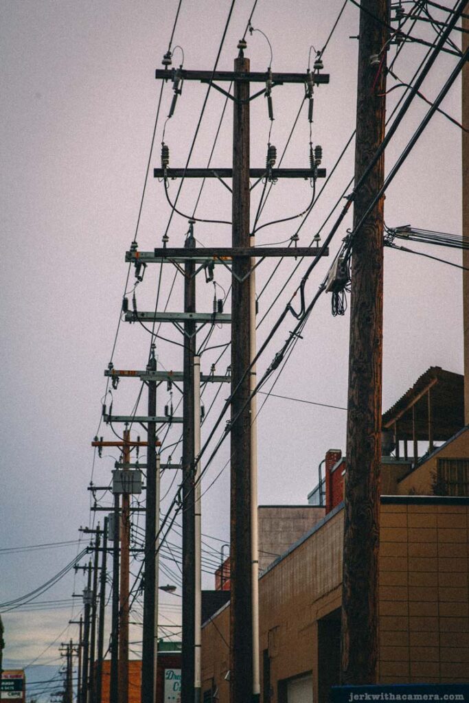 Utility poles and power lines running along an alley