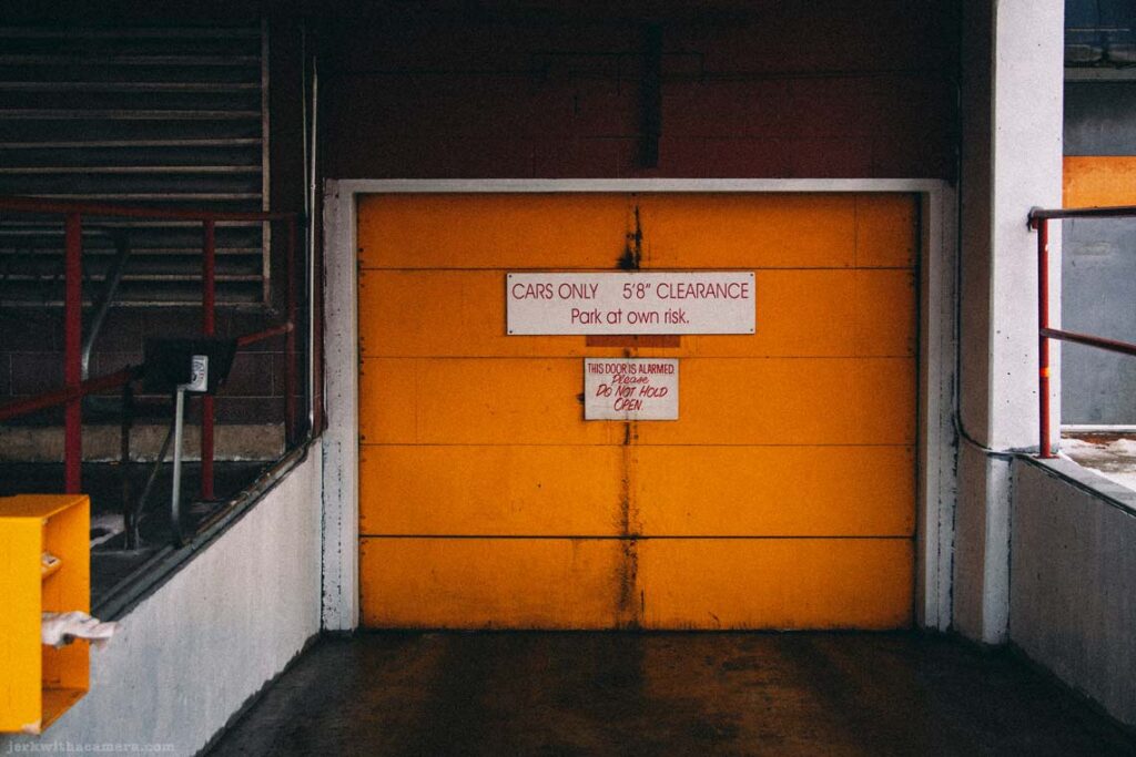 Yellow parking garage door with clearance sign