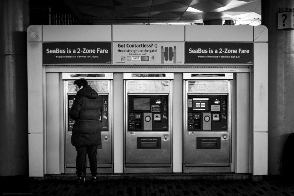 Person at SeaBus ticket machine in Vancouver