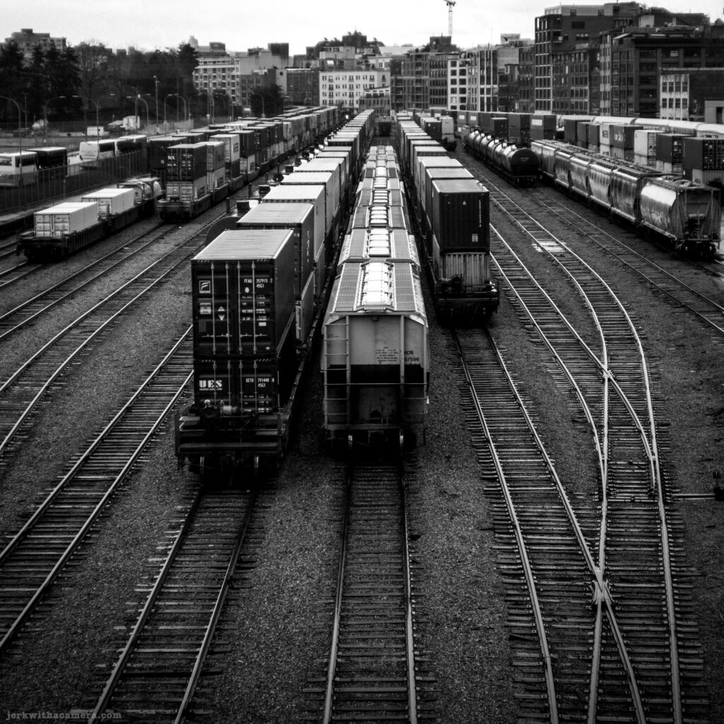 Train yard with freight cars and shipping containers