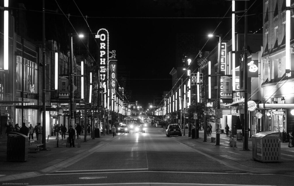 Granville Street with neon lights and signs for the Orpheum and Vogue theatres