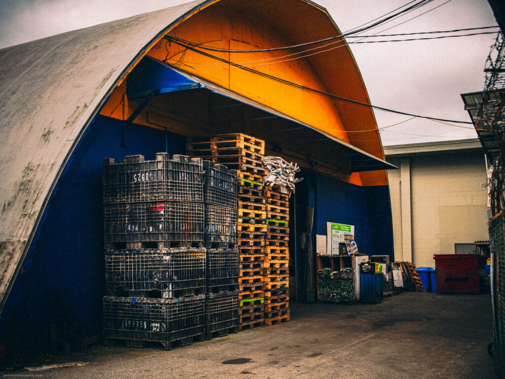 Stacks of crates and pallets in an industrial alley