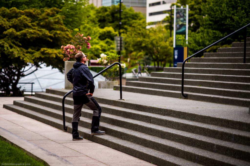 Man standing at the bottom of concrete stairs by Vancouver's Art Gallery